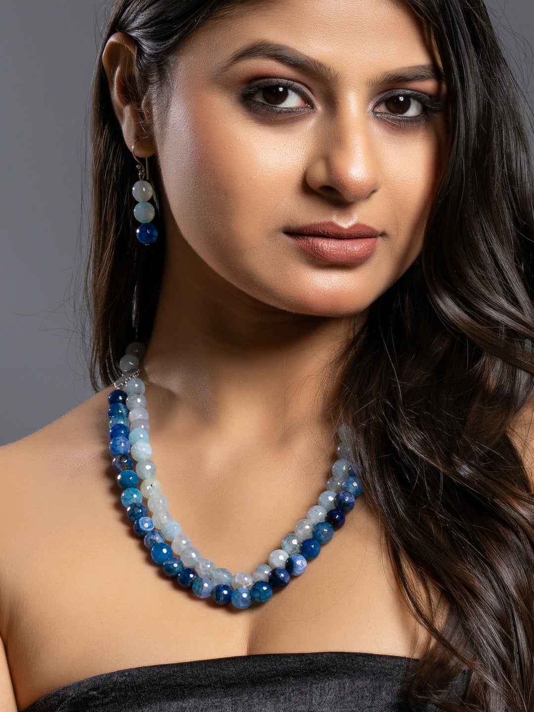Elegant onyx necklace set featuring blue and gray beads, perfect for adding a touch of charm