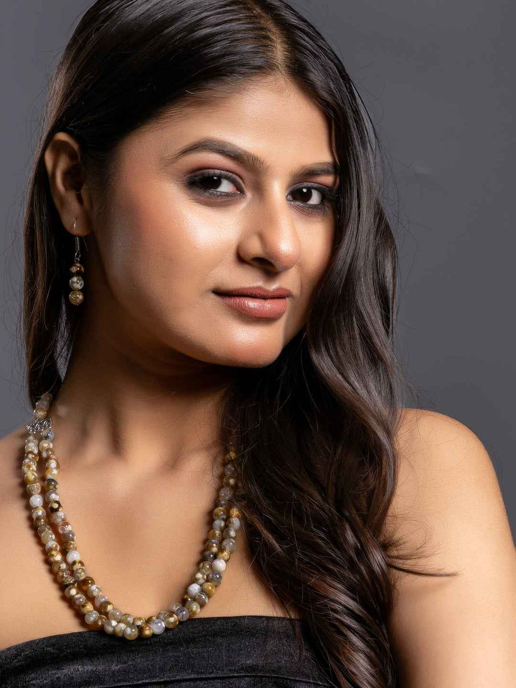 Handmade onyx necklace set with multi-colored beads, featuring elegant design worn by a model