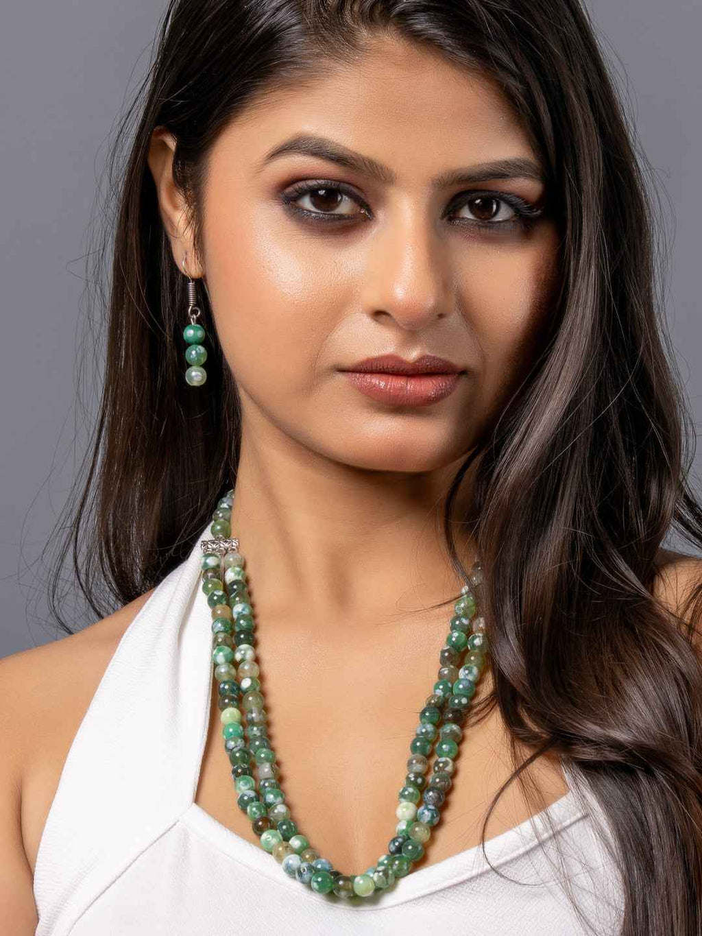 Handmade gemstone necklace set with various green hues and matching earrings, showcasing onyx necklace set