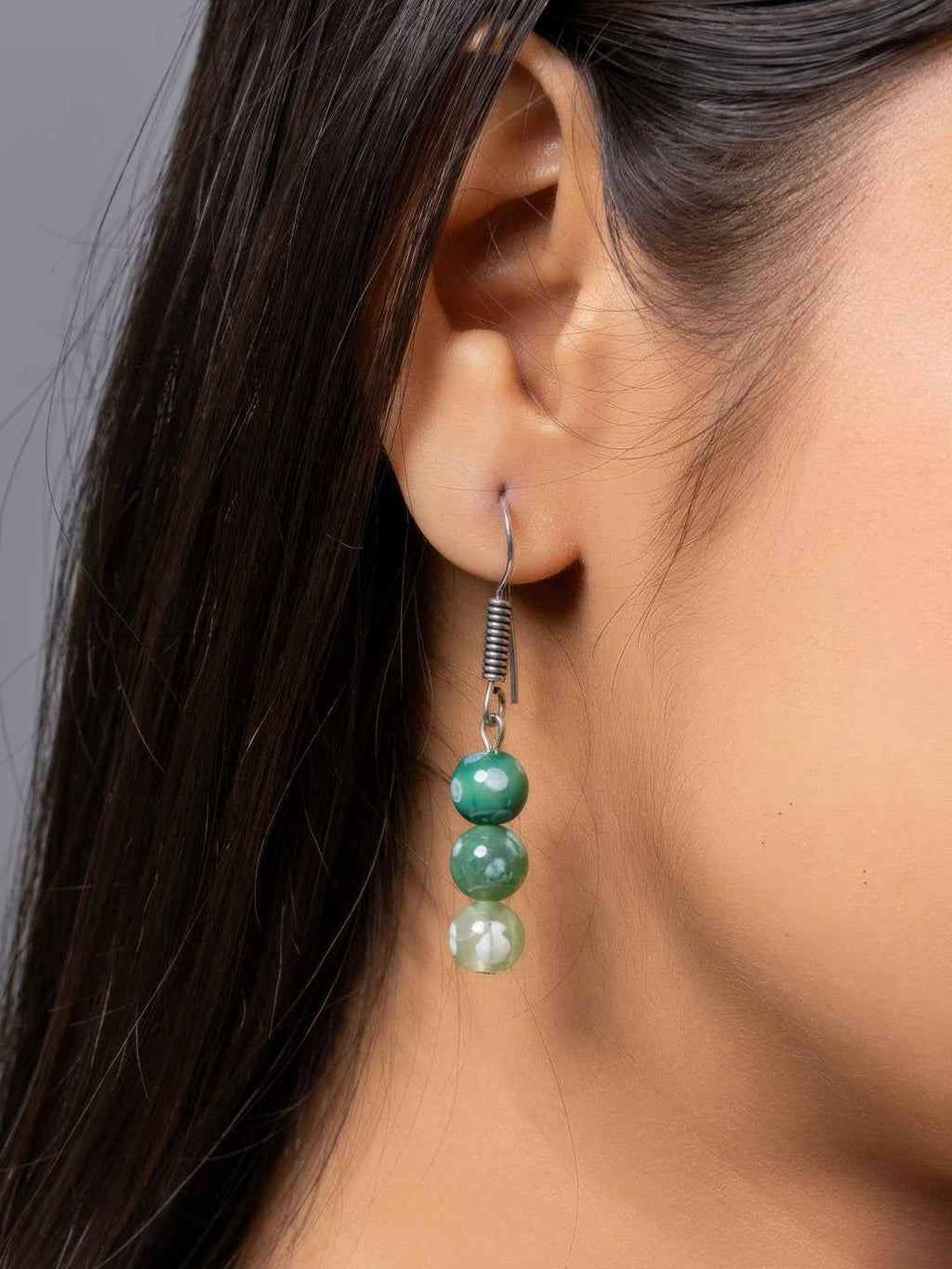Handmade green gemstone earrings featuring three stacked beads in varying shades, designed for elegance
