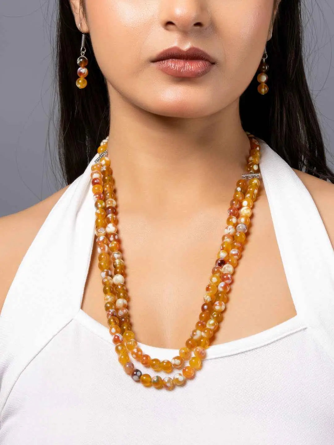 Handmade onyx necklace set with vibrant orange and yellow beads, featuring a layered design for a striking look