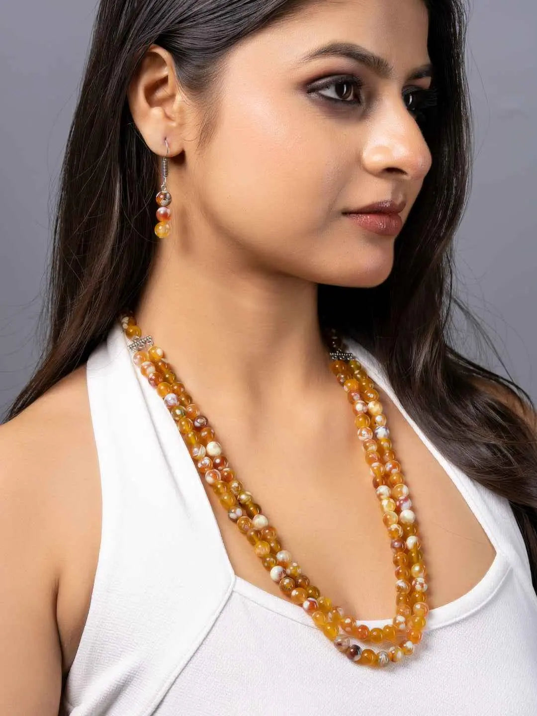 Handmade onyx necklace set in earthy tones with intricate bead design, perfect for elegant outfits
