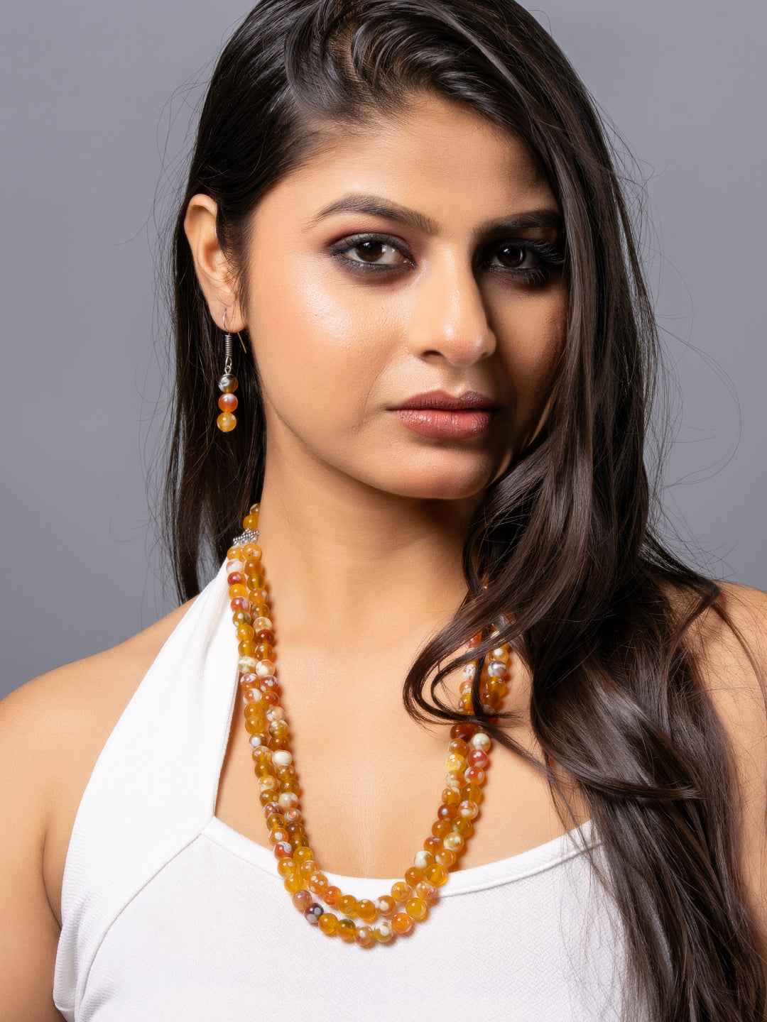 Handmade onyx necklace set featuring vibrant amber beads, elegant in design, perfect for any occasion