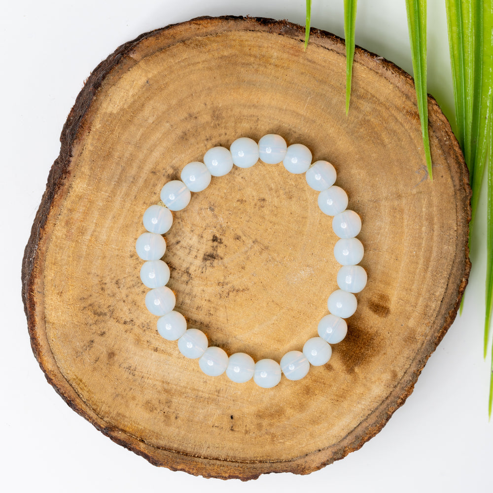 Opalite bracelet crafted by LOOK AND ADORN with a soothing, translucent finish on a natural wood display