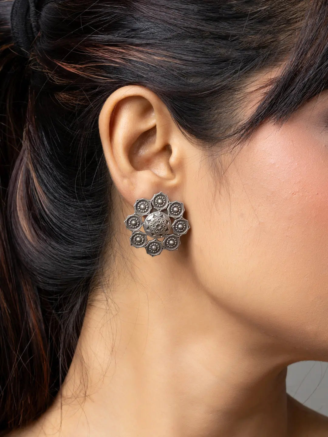 LOOK AND ADORN oxidised earrings in oxidised silver floral design worn on ear
