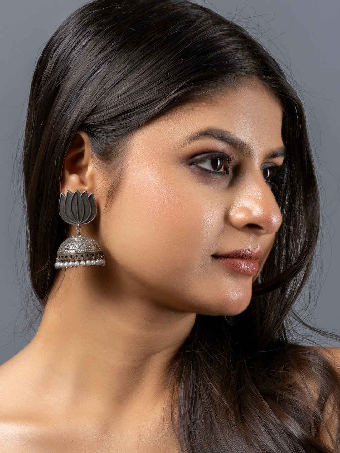Oxidised earrings with a floral design and bell detail, featuring a silver finish and elegant style
