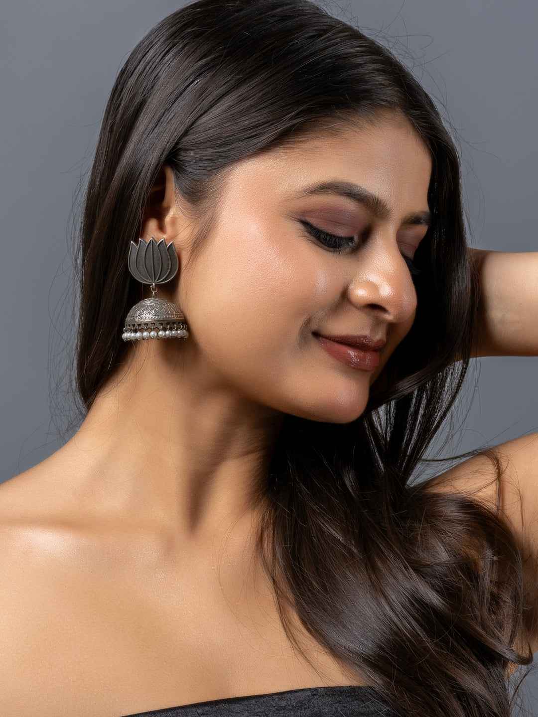 Oxidised earrings with a lotus design and pearl detailing, perfect for adding elegance to any outfit