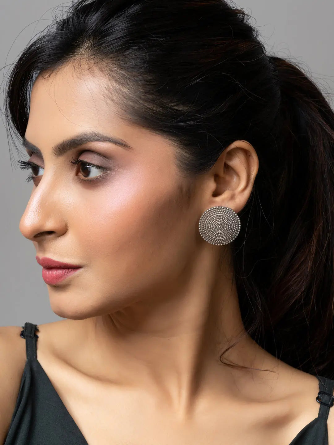 Woman wearing round oxidised earrings from LOOK AND ADORN oxidised silver collection