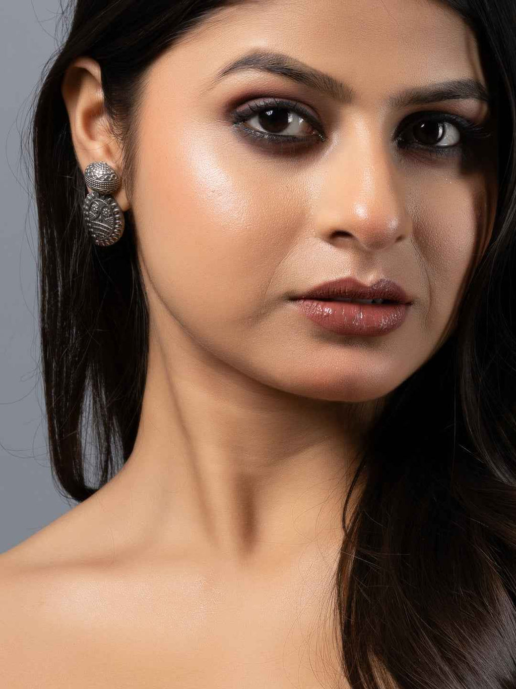 Oxidised earrings with intricate floral design, featuring a dark silver finish for an elegant look