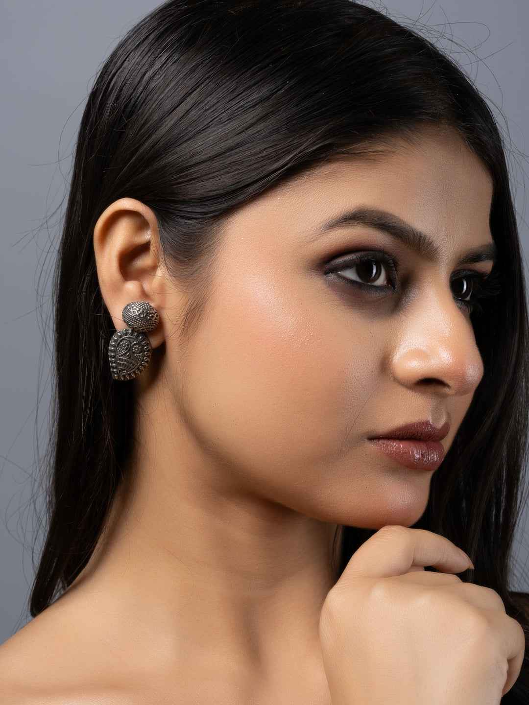 Oxidised earrings in a peacock design featuring intricate detailing and an antique silver finish