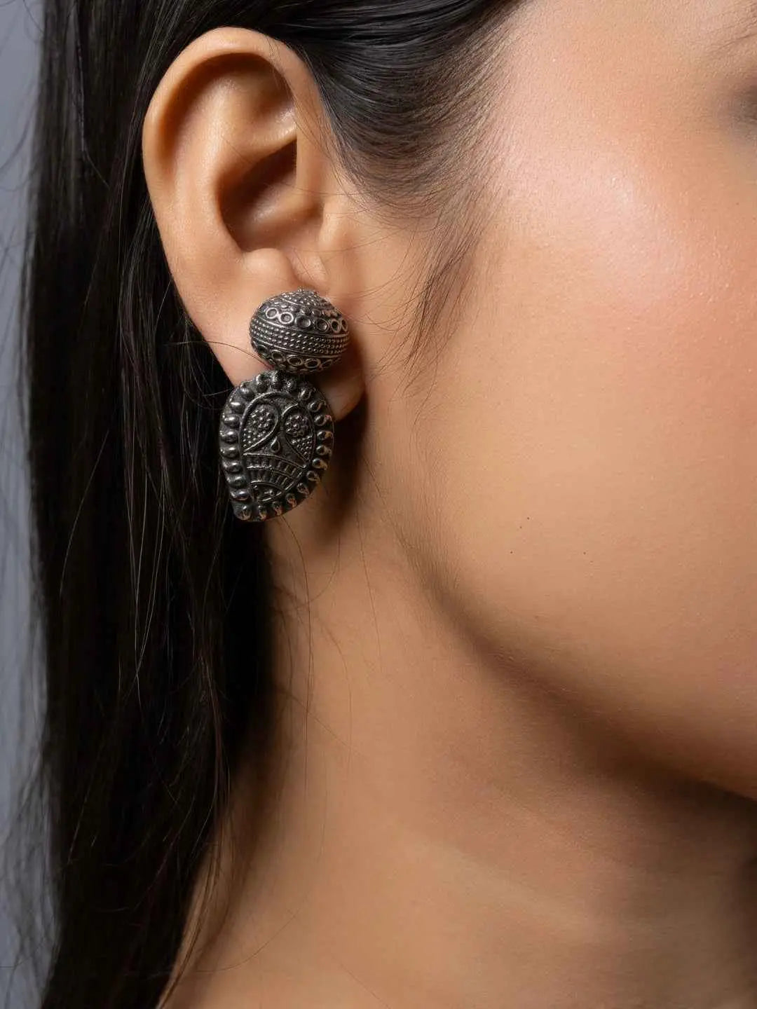 Oxidised earrings featuring intricate leaf designs in dark silver tone for a stylish vintage look