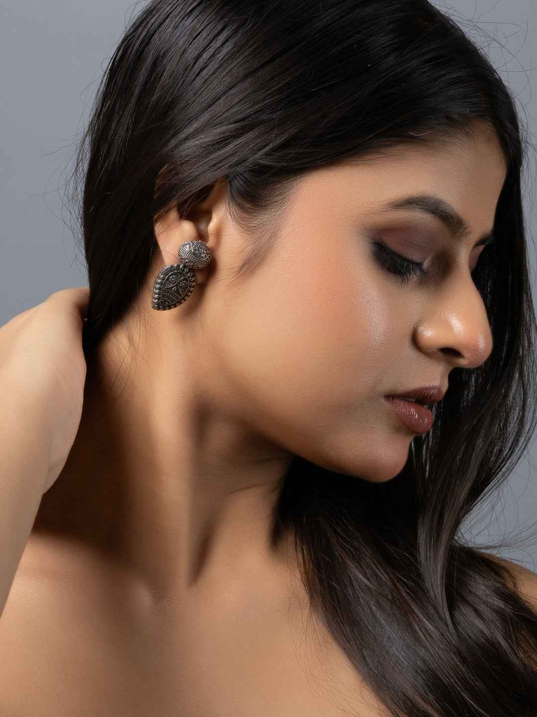 Oxidised earrings featuring a peacock design with intricate detailing in dark silver finish