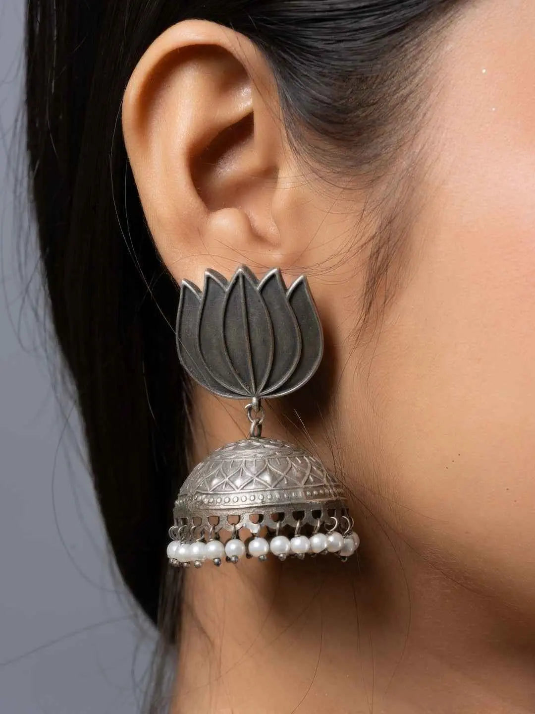Oxidised earrings in lotus flower design with silver plating and dangling pearl beads