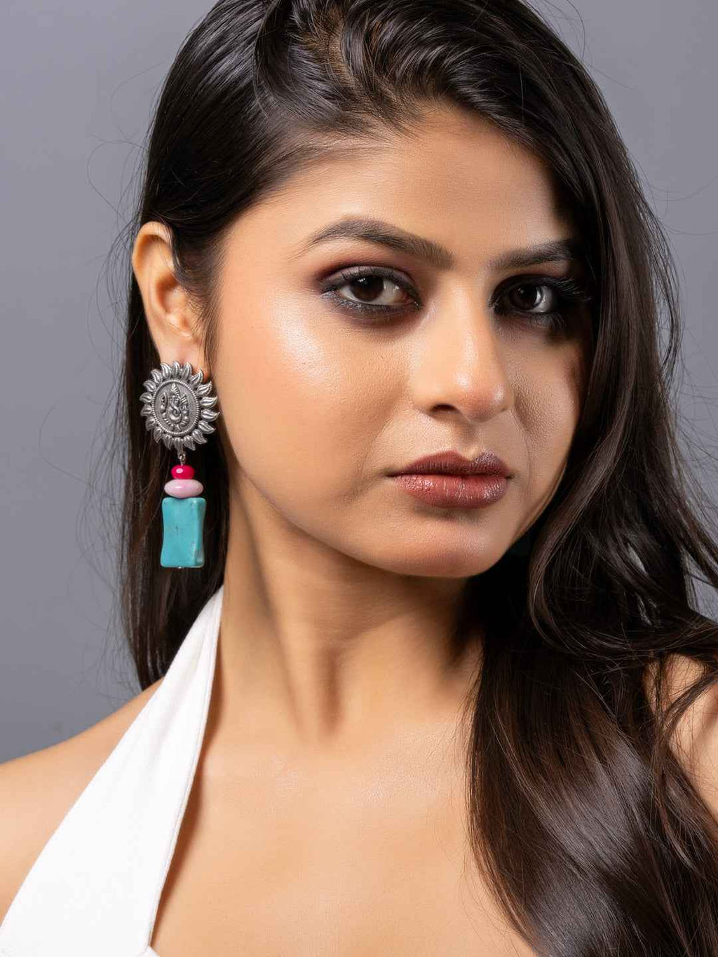 Oxidised earrings featuring a silver sun design with turquoise and pink accents, perfect for a stylish look