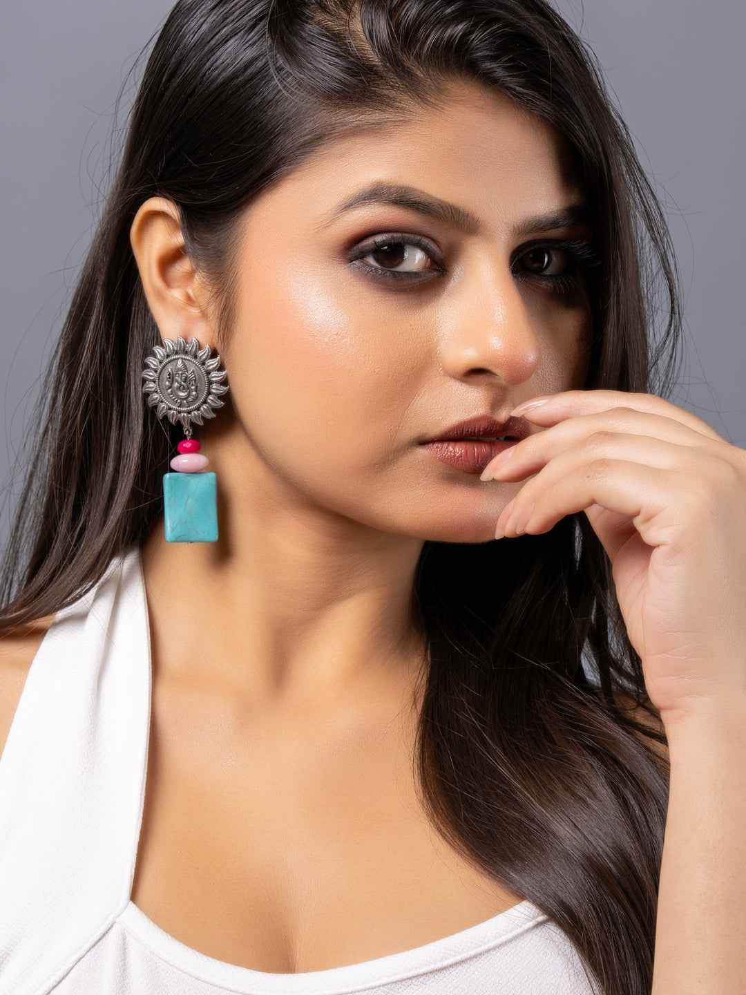 Oxidised earrings with a sun design, featuring a turquoise square bead and pink accents