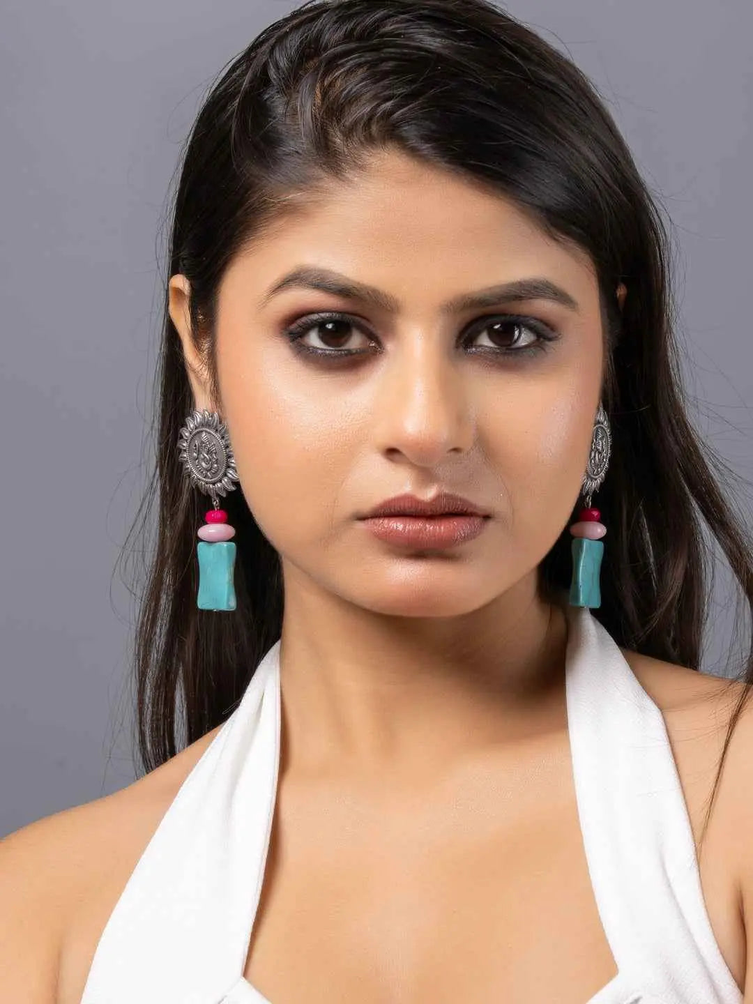 Oxidised earrings with turquoise and pink accent beads, featuring intricate detailing in silver design