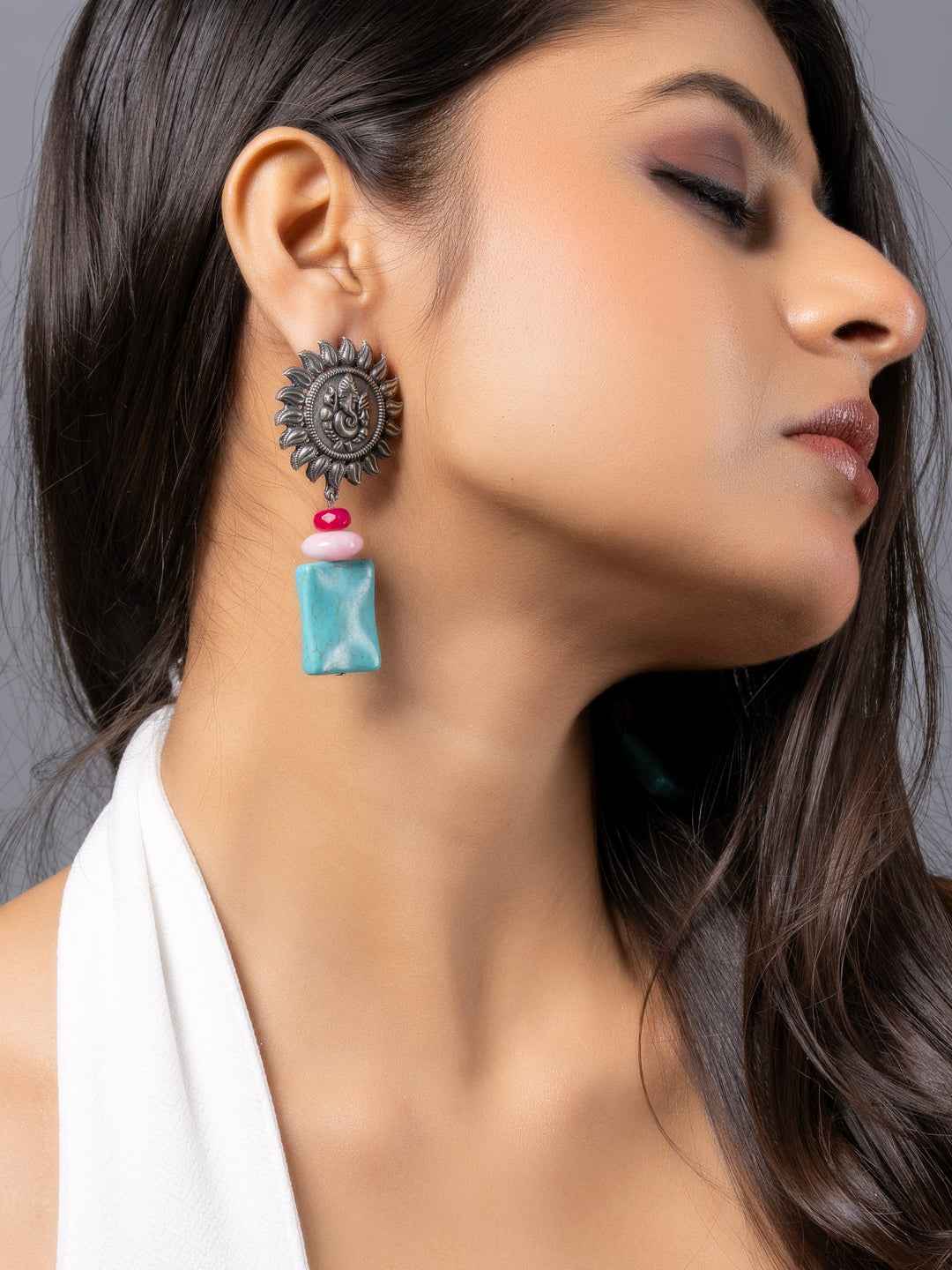 Oxidised earrings featuring a sunburst design with turquoise and pink accents for a unique style