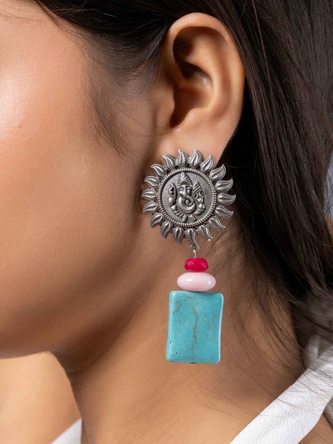 Oxidised earrings with a sun motif, featuring turquoise and pink beads for a vibrant look
