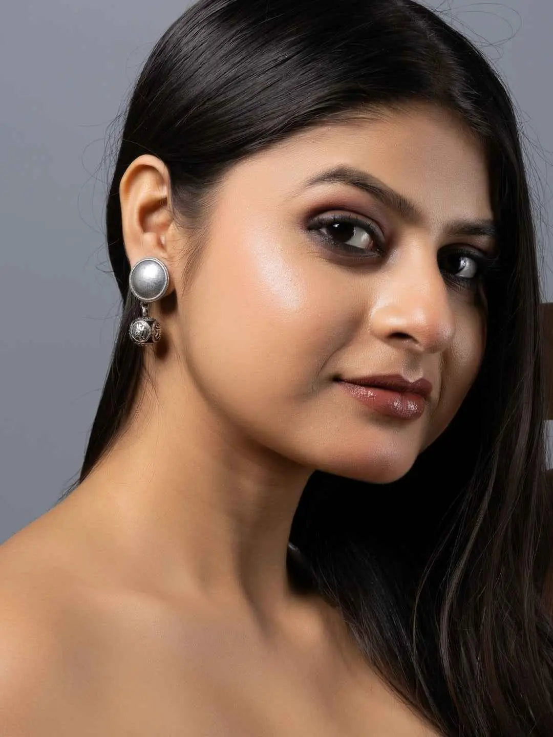 Oxidised earrings featuring a round design with silver accents for a chic and elegant look