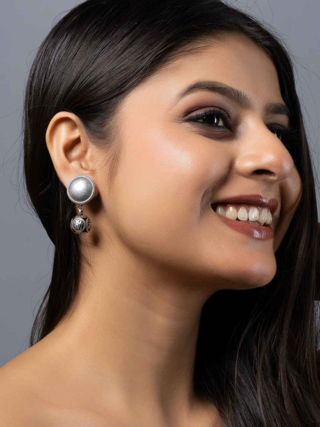 Oxidised earrings featuring a circular design with a textured finish in silver tones