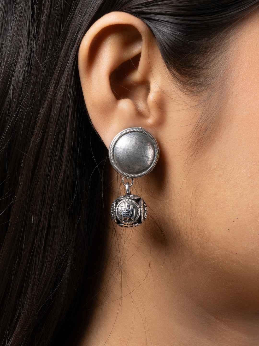 Oxidised earrings with a unique round stud and hanging detailed charm for a stylish look