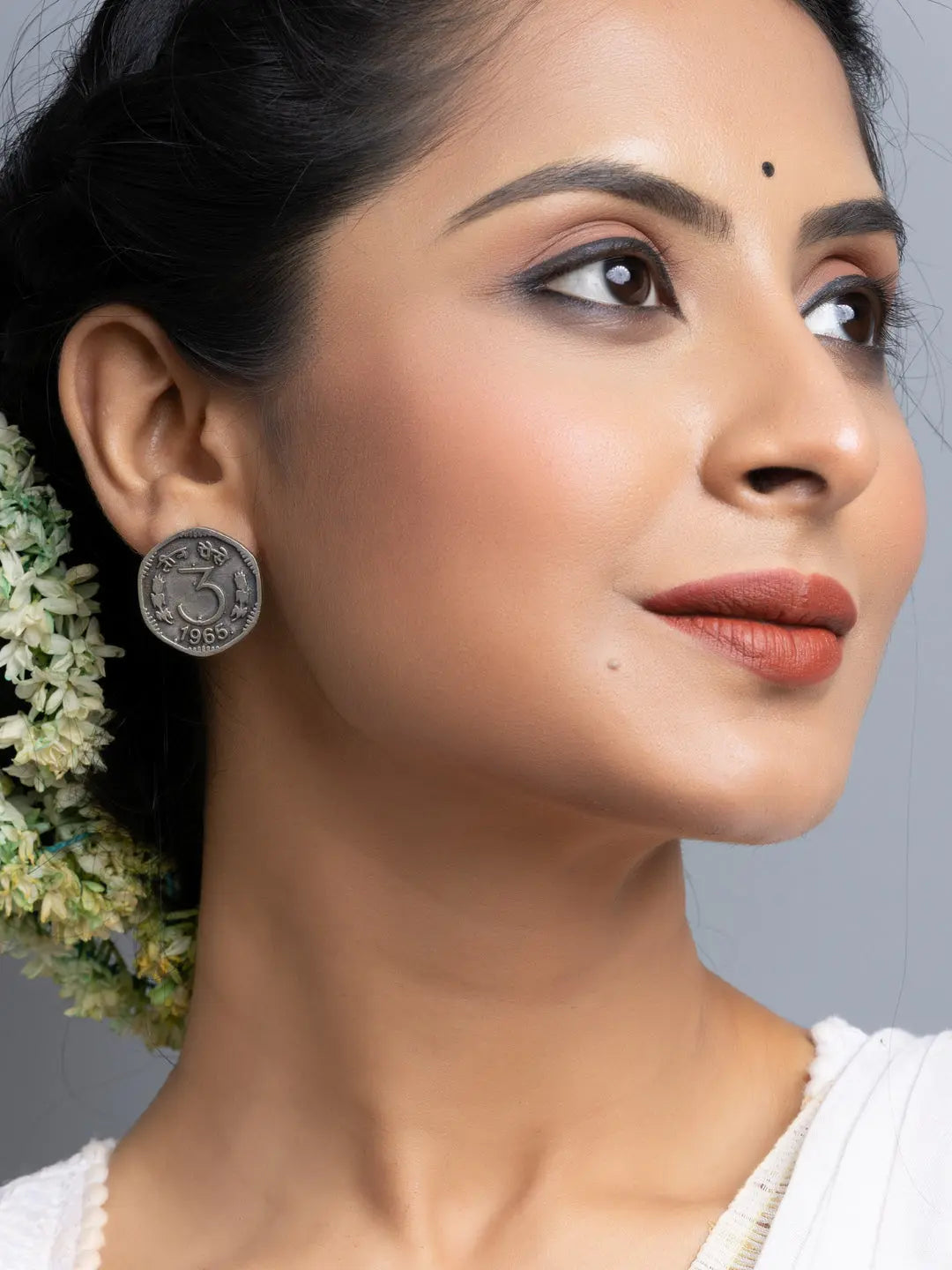 LOOK AND ADORN oxidised silver earrings worn by woman with floral hairstyle and subtle makeup