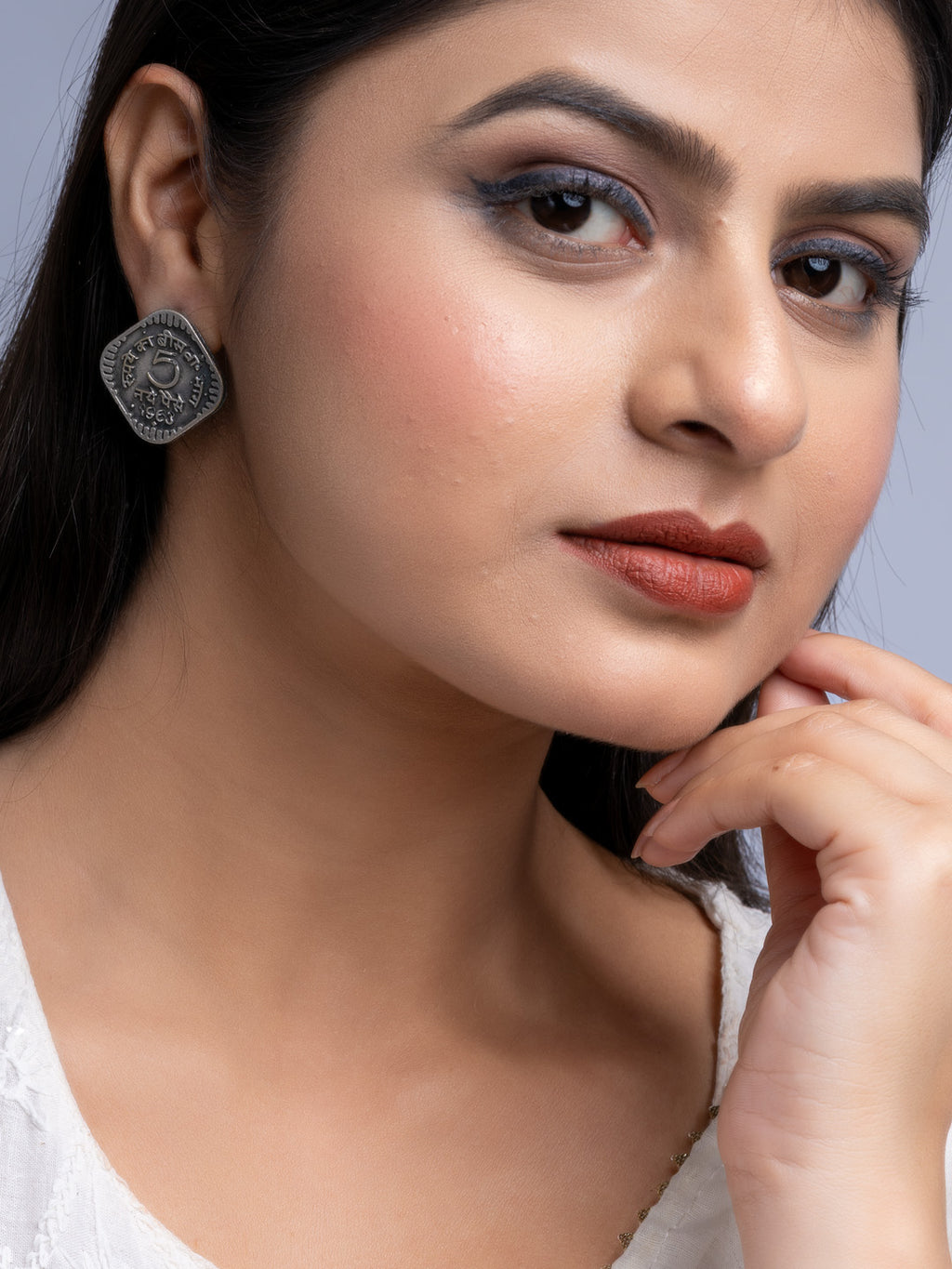 Woman wearing oxidised silver earrings from LOOK AND ADORN with detailed intricate design close-up