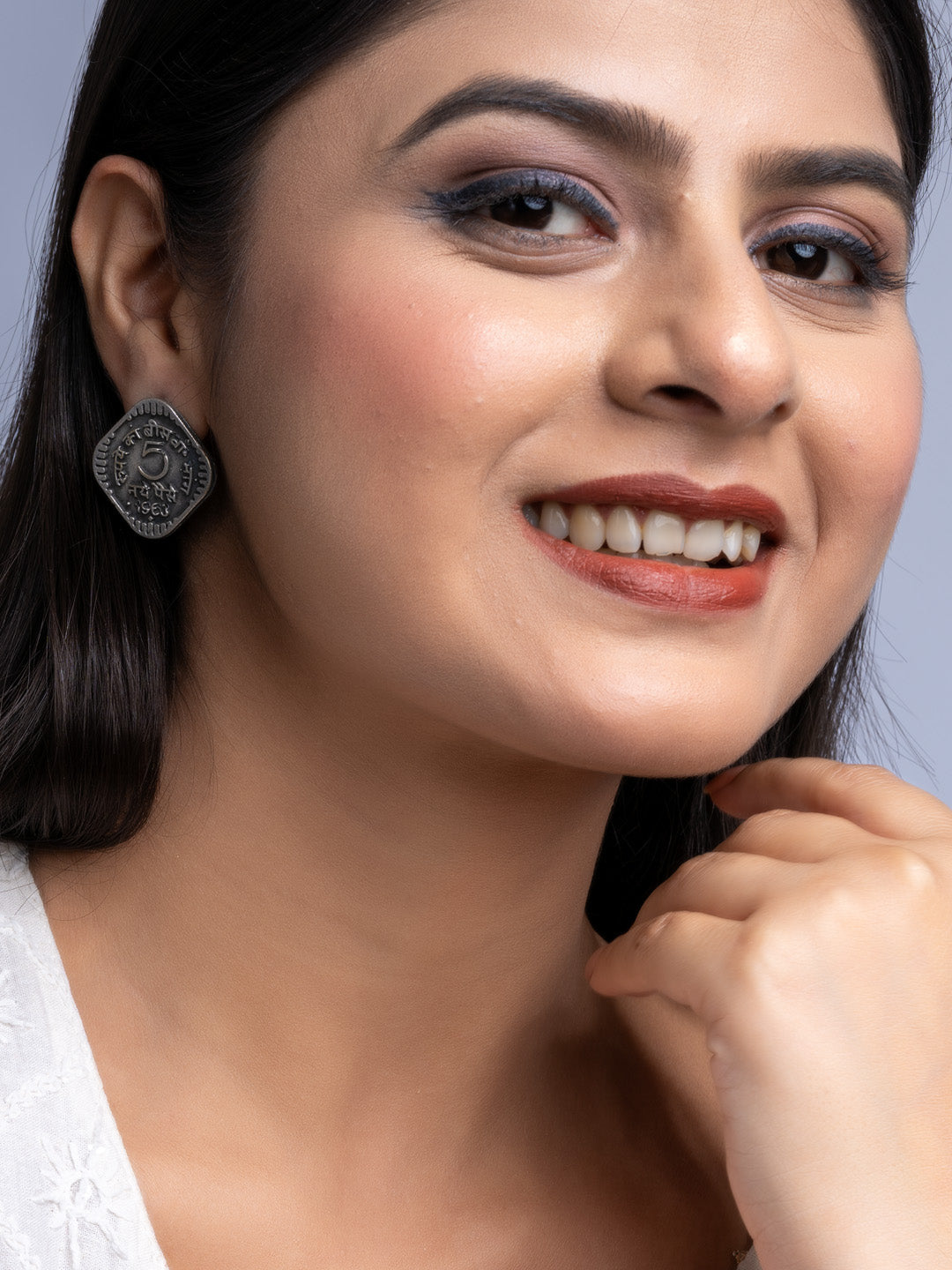 Smiling woman wearing oxidised silver earrings from LOOK AND ADORN with detailed design