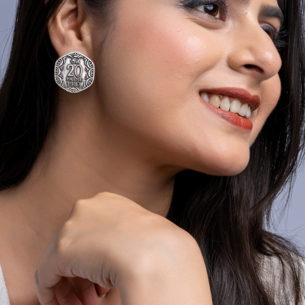 Close-up of woman wearing oxidised silver earrings with intricate design from LOOK AND ADORN