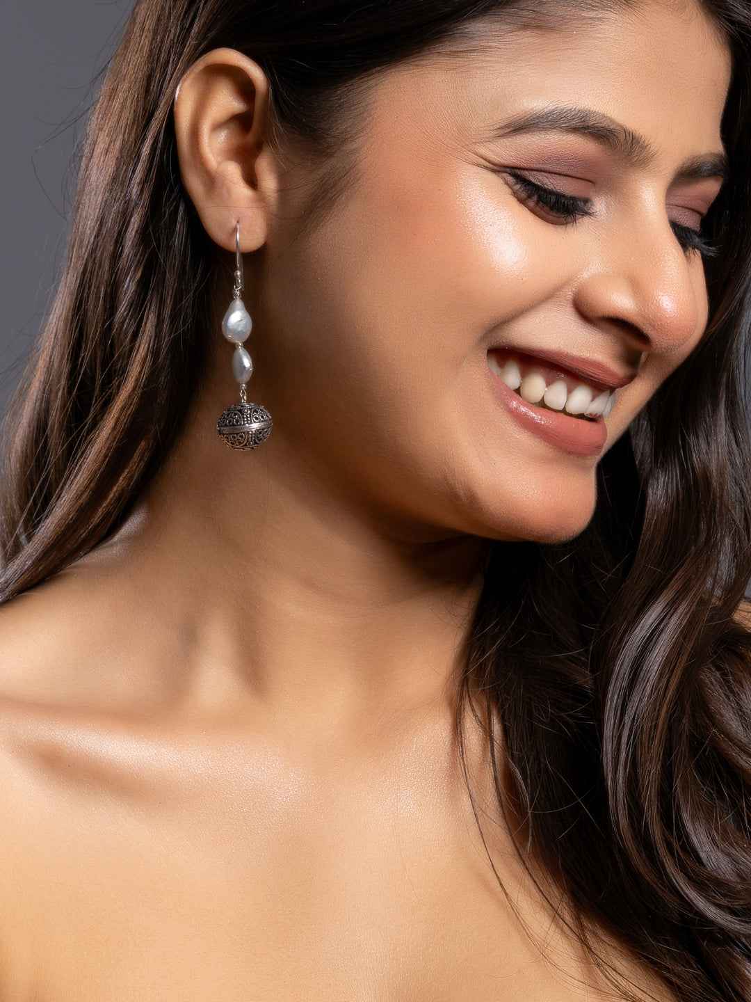 Elegant silver pearl earrings with intricate design and classic drop style for a chic look