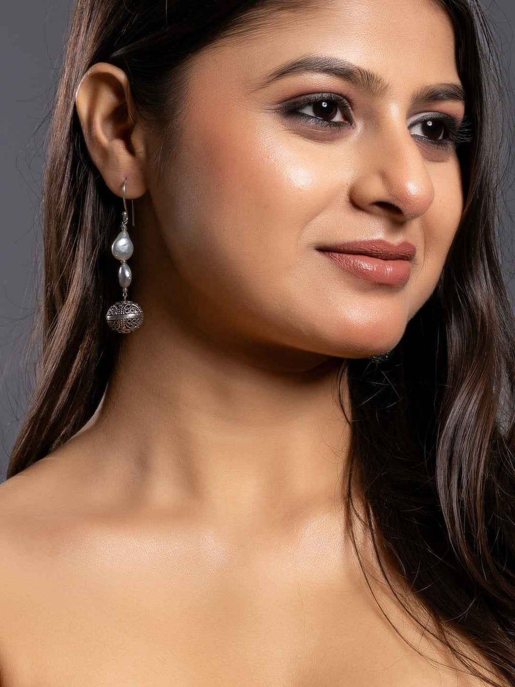 Elegant silver pearl earrings featuring a delicate design with a charming drop detail