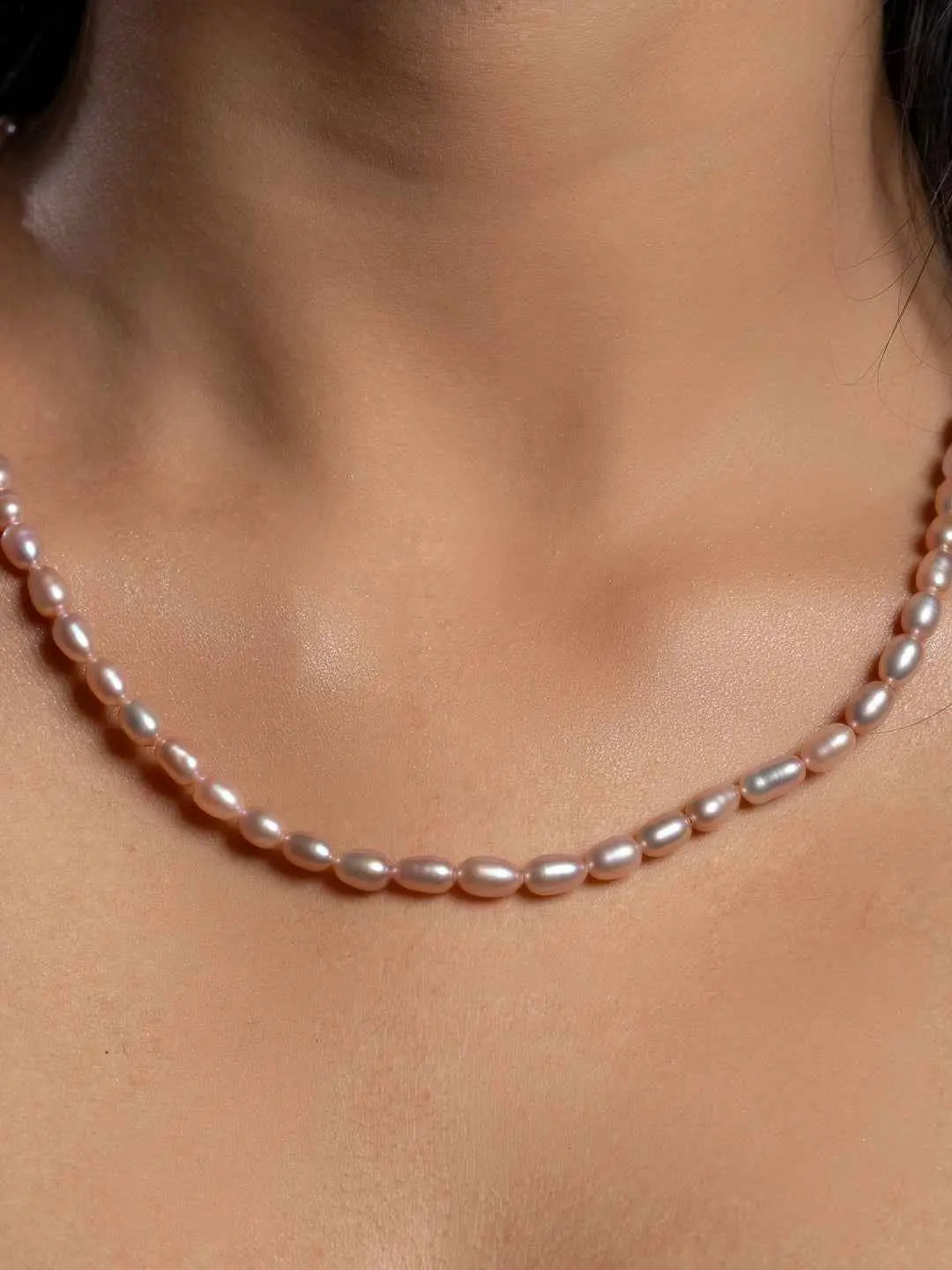 Delicate pink pearl necklace set featuring smooth, lustrous pearls for elegant styling