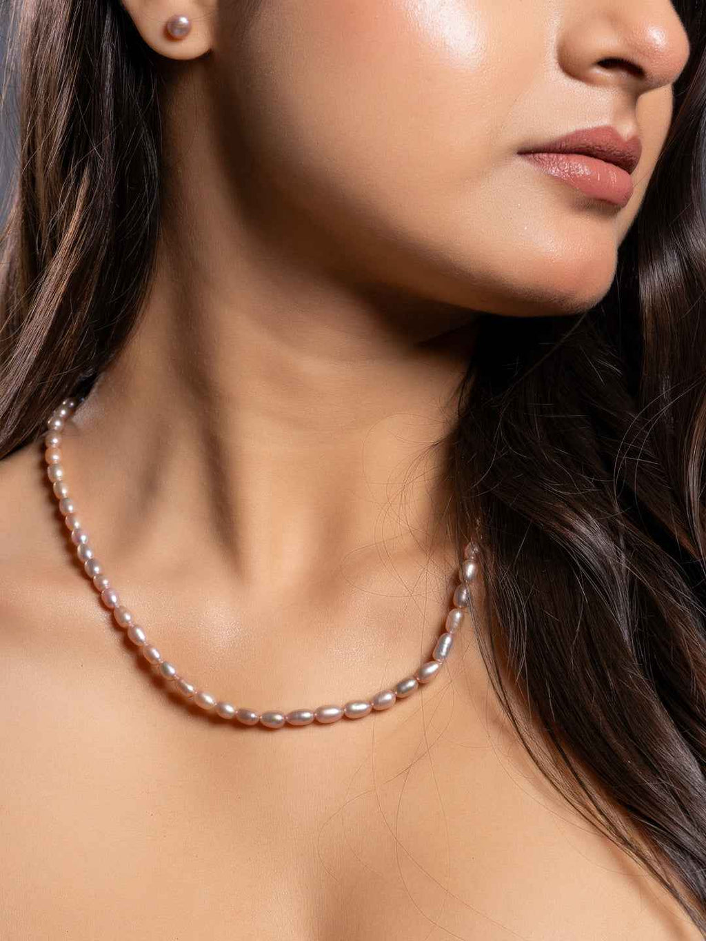 Handmade pearl necklace set in soft pink, featuring elegant smooth pearls for a classic look