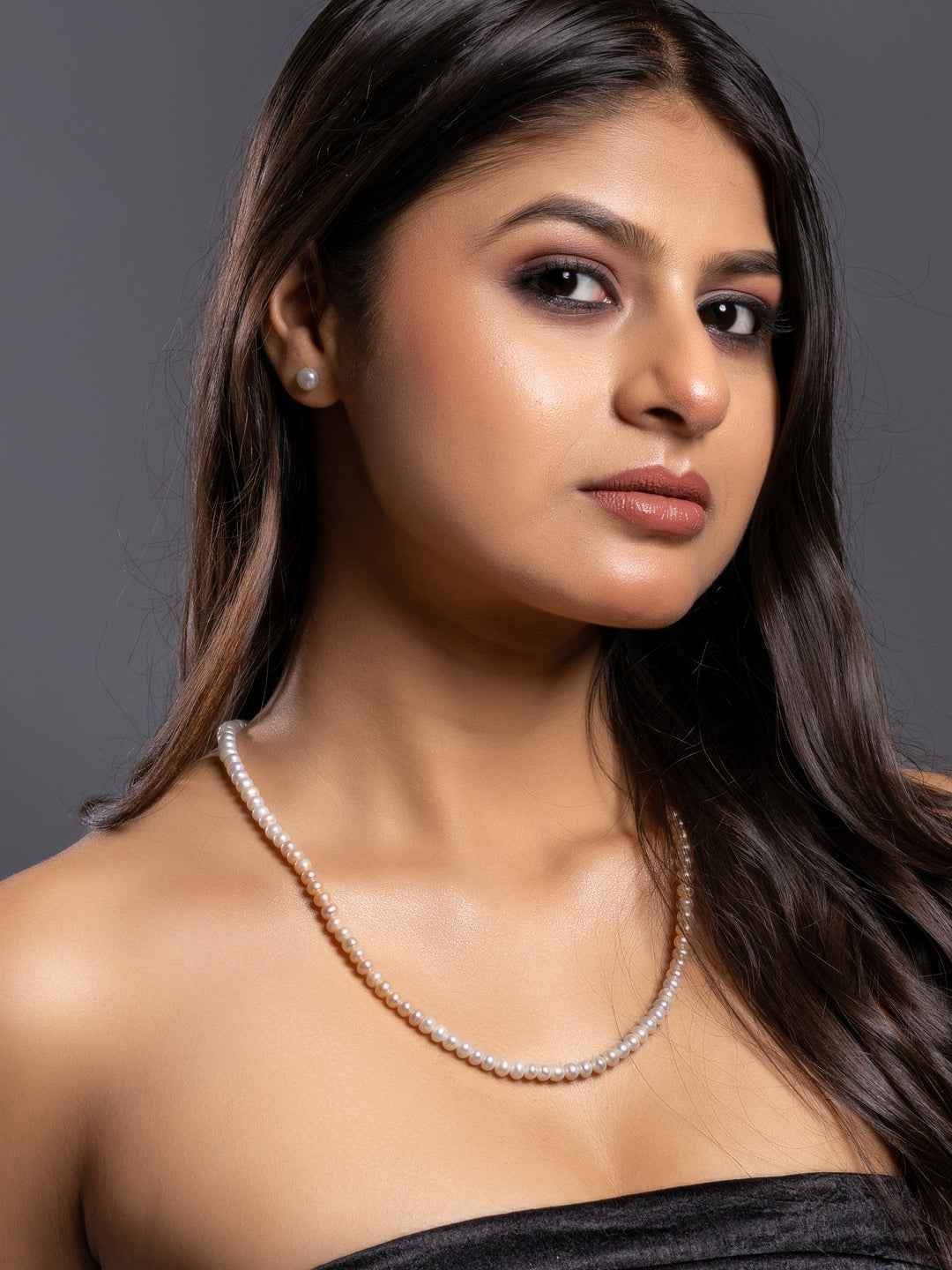 Elegant pearl necklace set in classic white, paired with matching earrings for a sophisticated look
