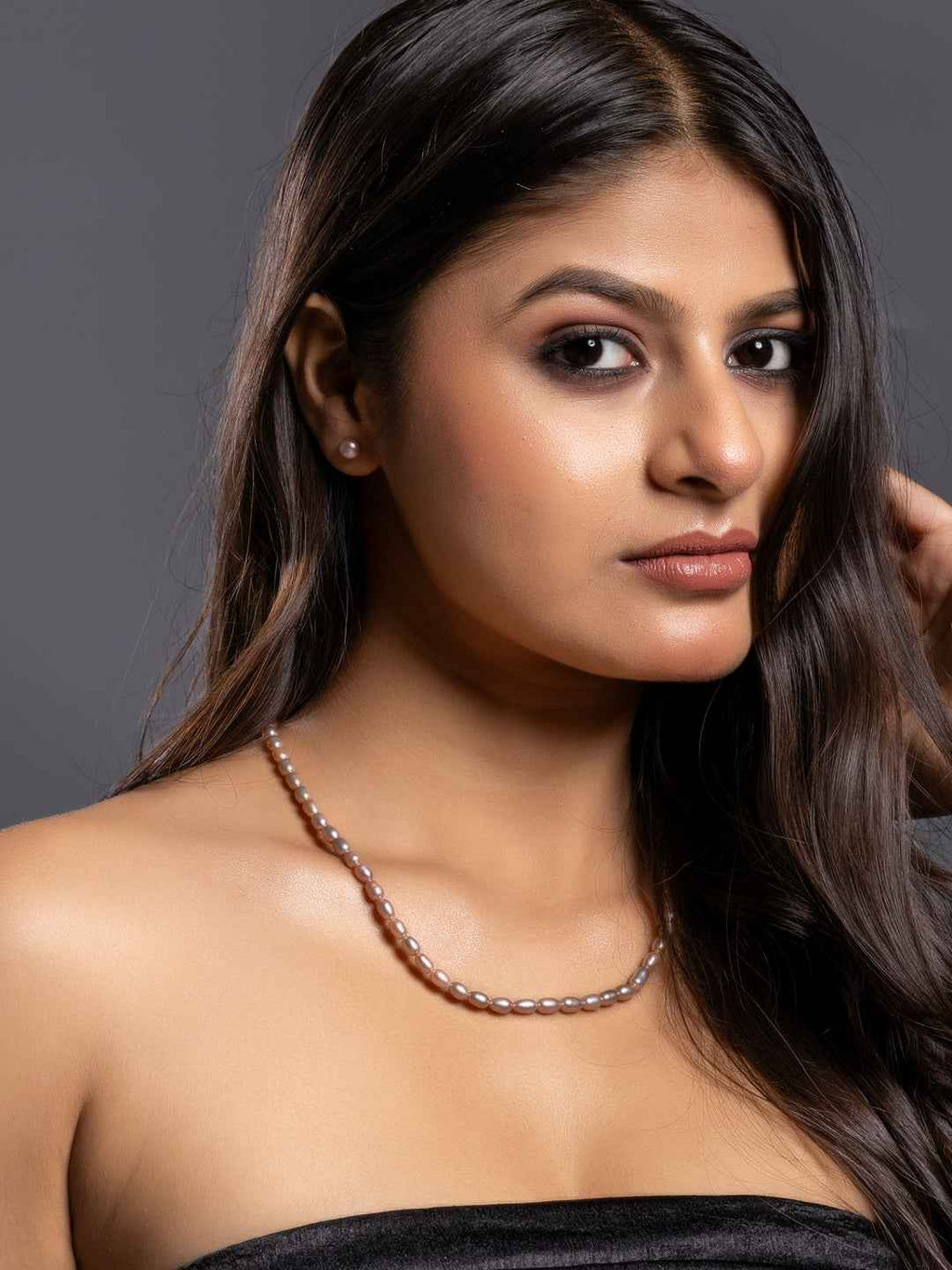 Elegant handcrafted pearl necklace set in soft pink hues, perfect for formal occasions