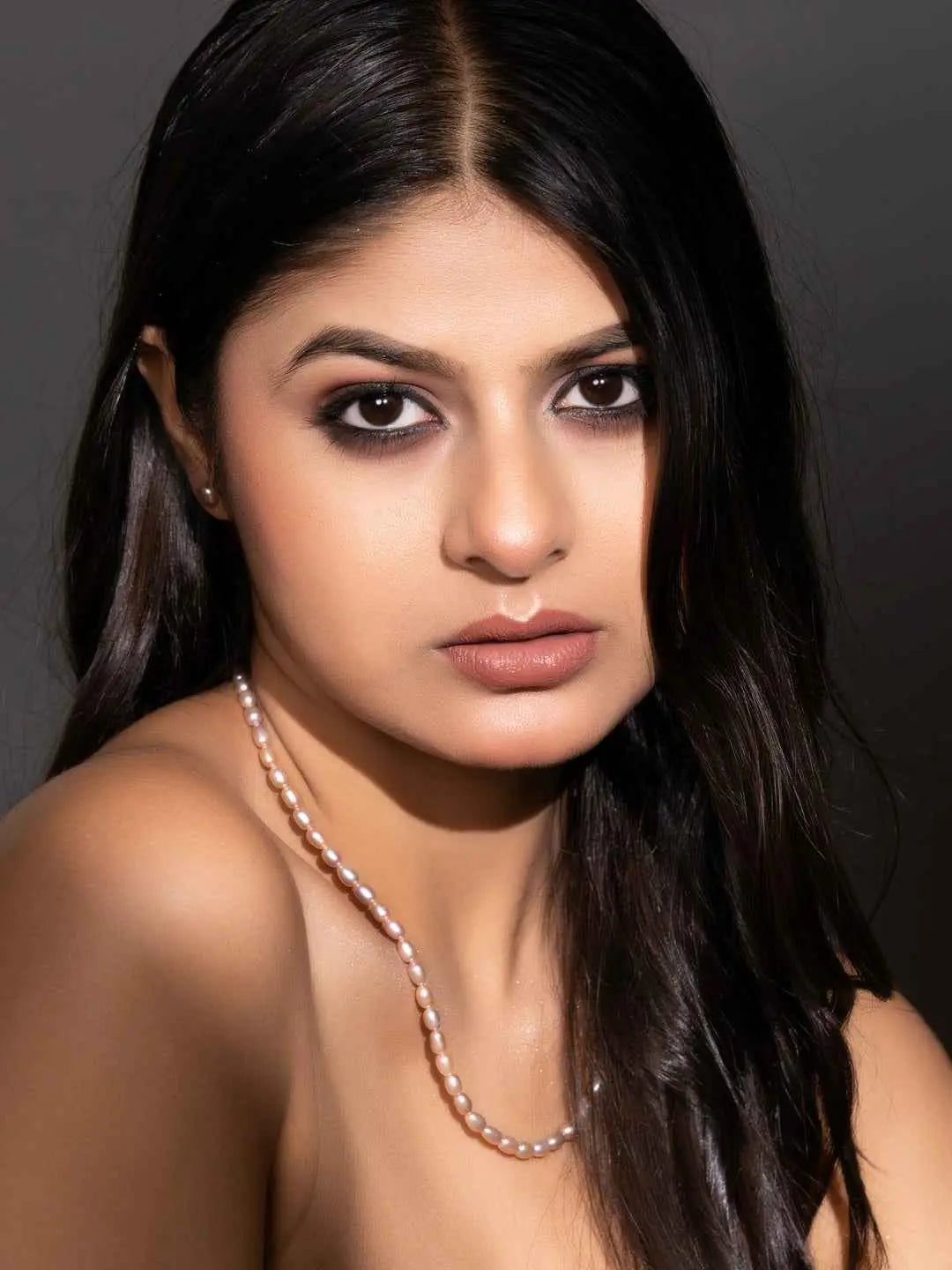 Elegant handmade pearl necklace set featuring soft pink pearls on a model with dark hair
