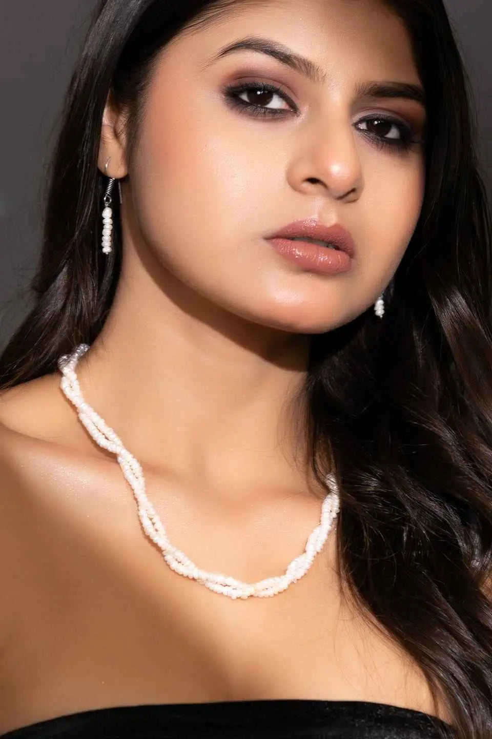 Handmade pearl necklace set featuring twisted white pearls and matching earrings for elegant style