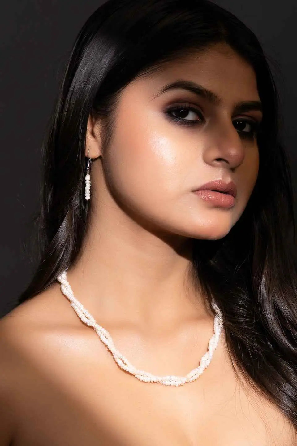 Elegant handmade pearl necklace set with twisted strands and matching earrings for a sophisticated look