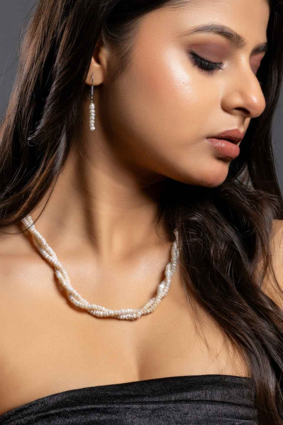 Elegant handmade pearl necklace set featuring twisted creamy white pearls and matching earrings
