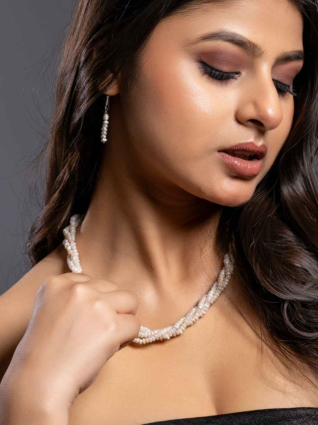 Elegant pearl necklace set featuring layered strands of white pearls with matching earrings