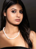 Handmade pearl necklace set with a twist design, elegantly worn by a model with long dark hair