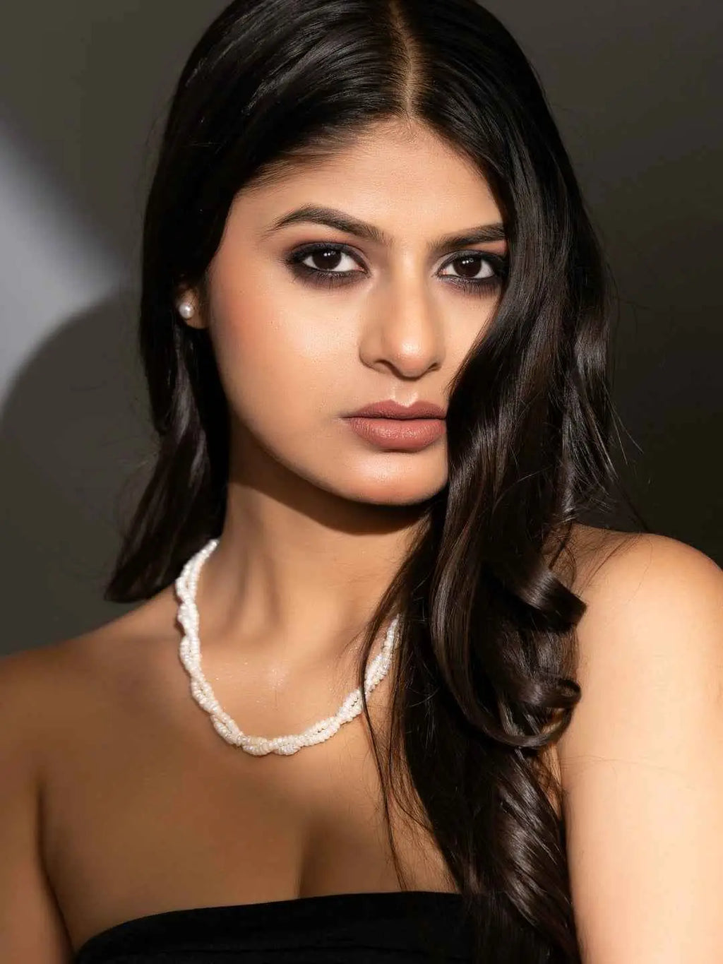 Handmade pearl necklace set with intricate twisted design, featuring elegant white pearls