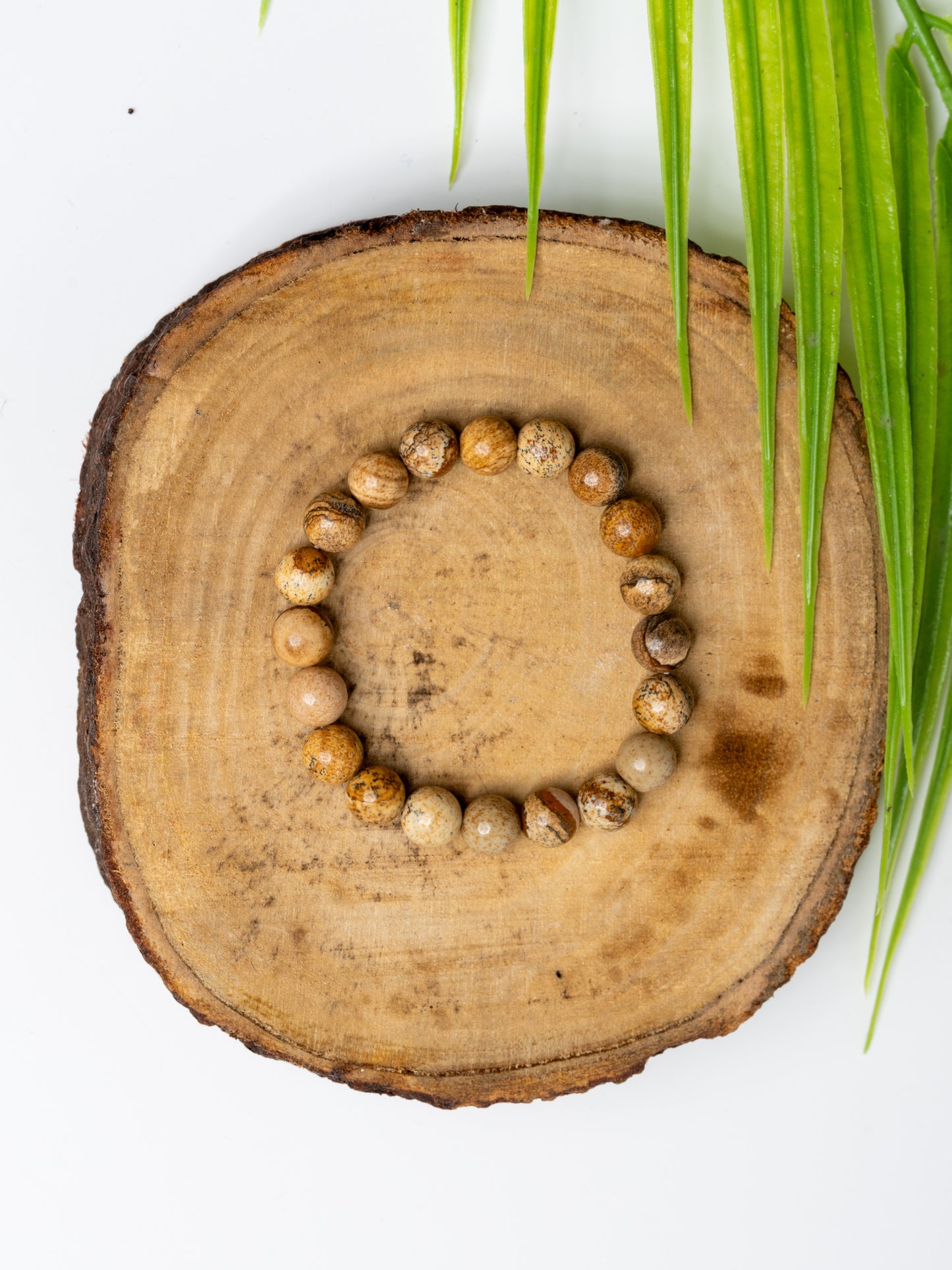 LOOK AND ADORN Astro-Gemstone Bracelet in Earthy Tones on a Wooden Surface