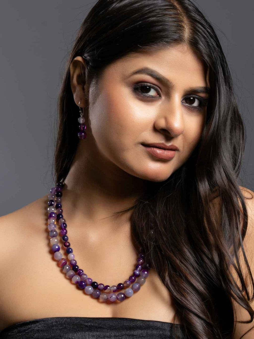 Purple onyx necklace set featuring multiple layers with matching earrings, showcasing elegant style and rich color.