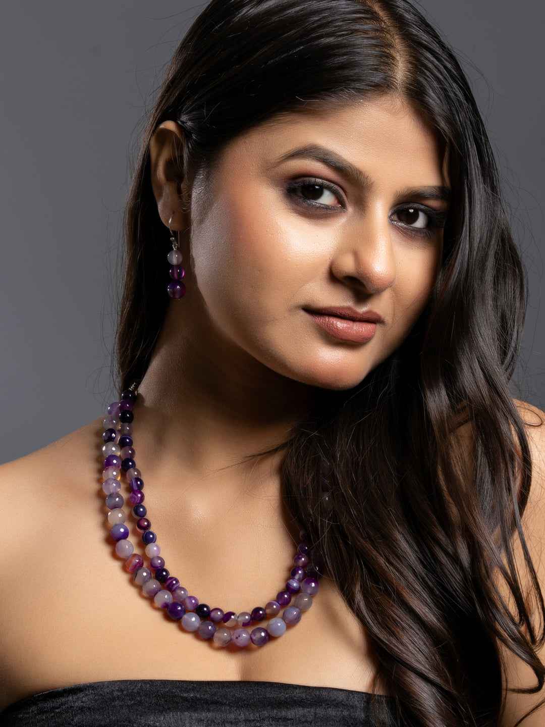 Purple onyx necklace set featuring multiple layers with matching earrings, showcasing elegant style and rich color.