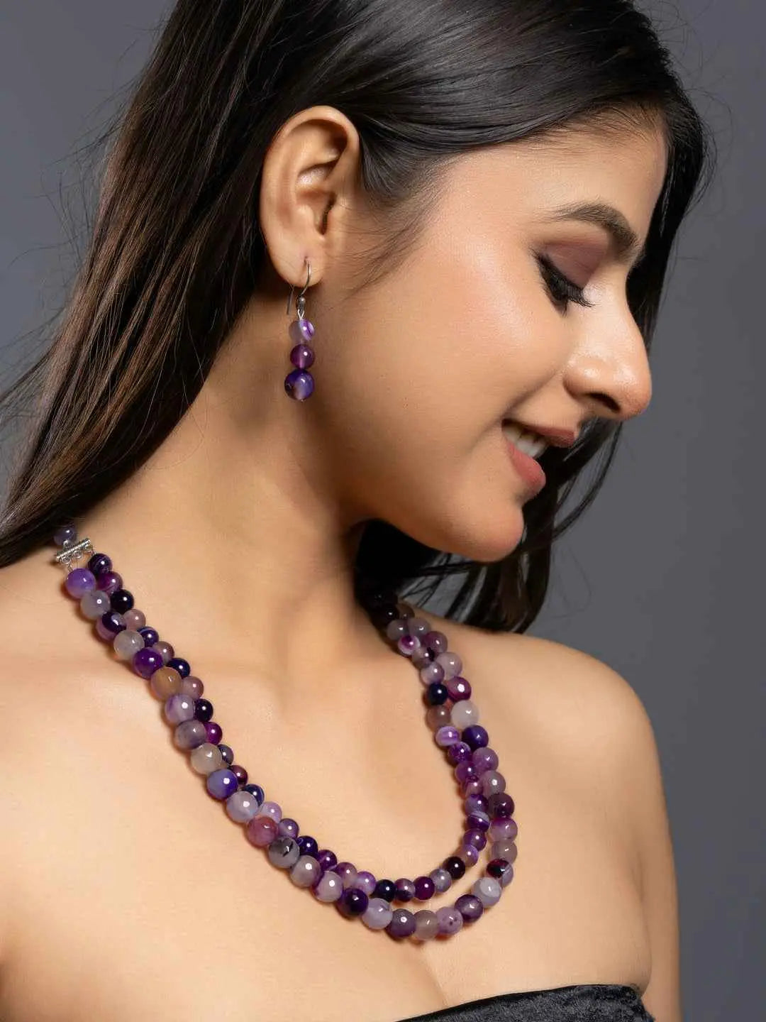 Elegant purple onyx necklace set with varying shades of purple beads and matching earrings for a stylish look