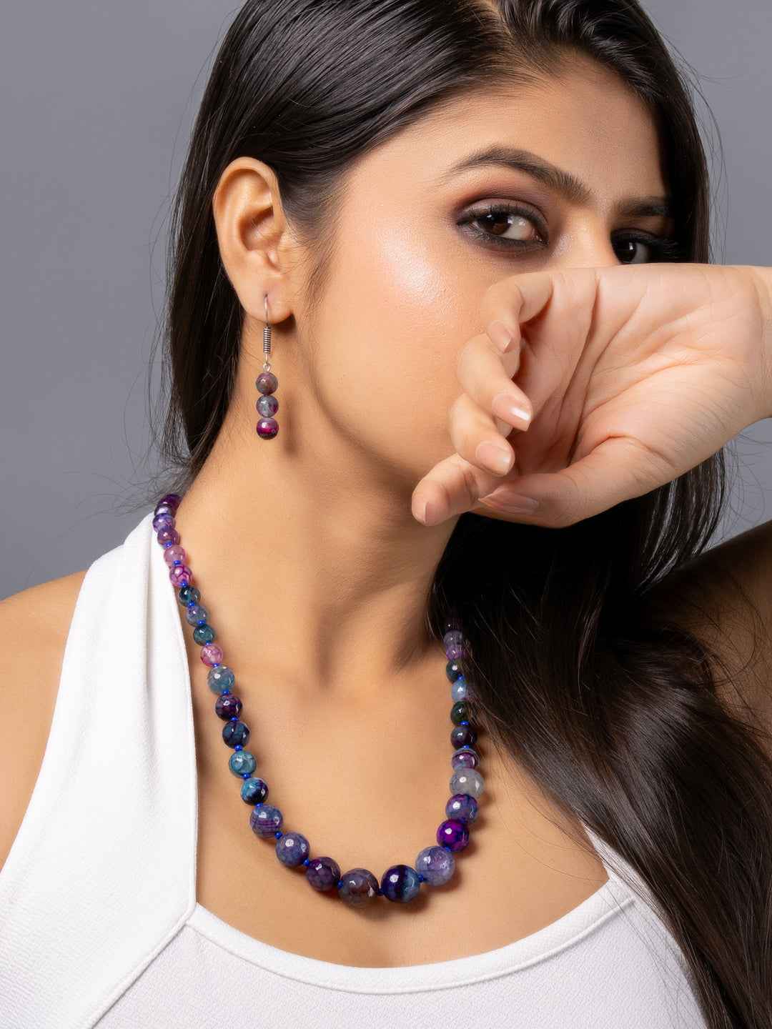 Purple onyx necklace set with smooth beads, paired with matching earrings, exuding elegance and sophistication