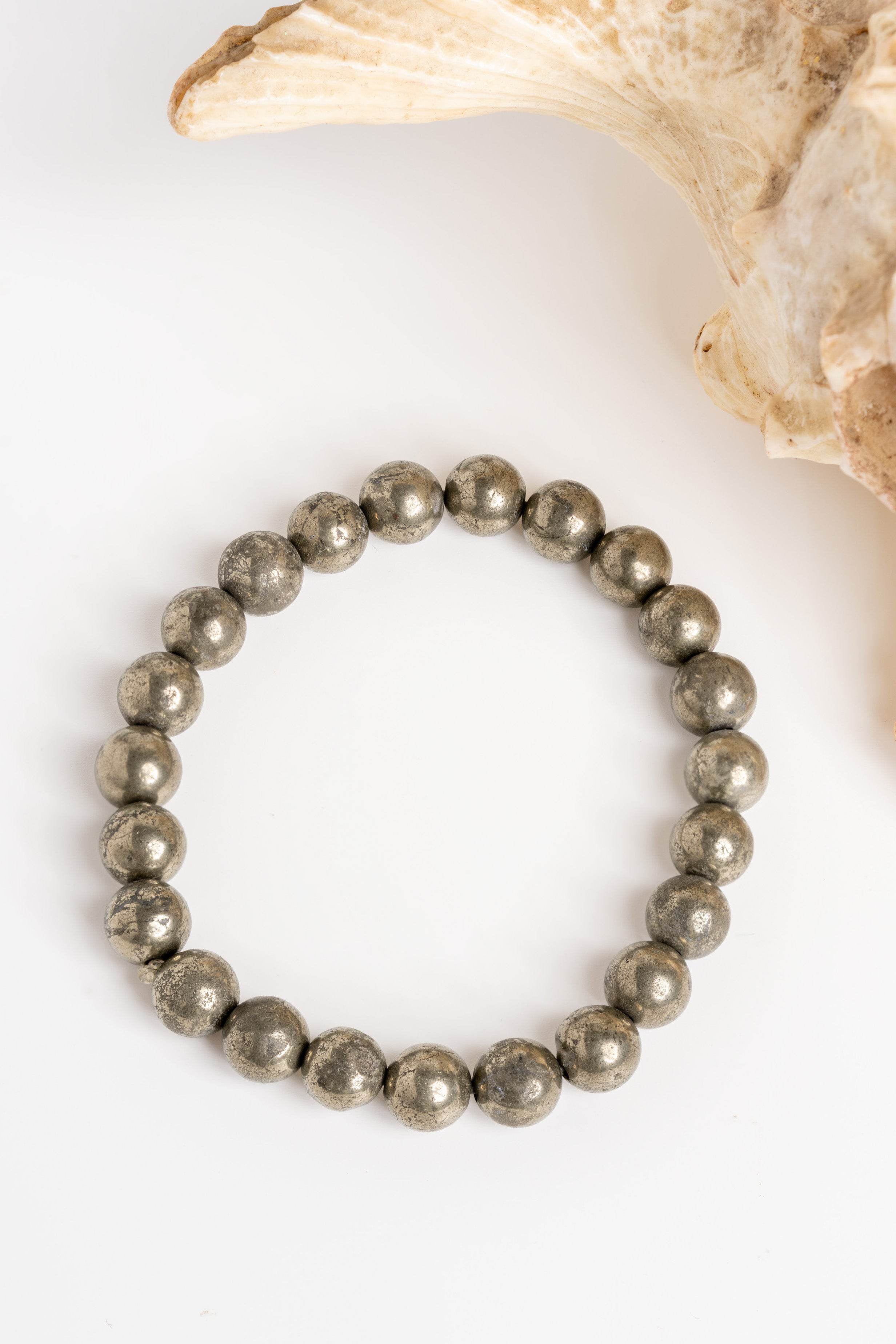 Raw pyrite bracelet with polished spherical beads, perfect for adding a touch of elegance