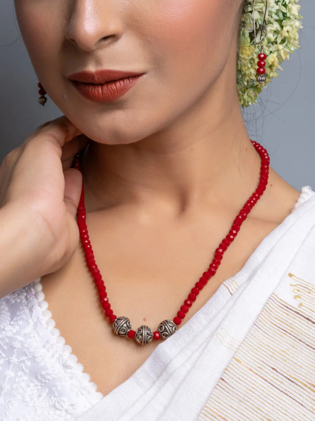 Handmade Red Crystal Necklace Set with silver beads worn by woman in white traditional attire