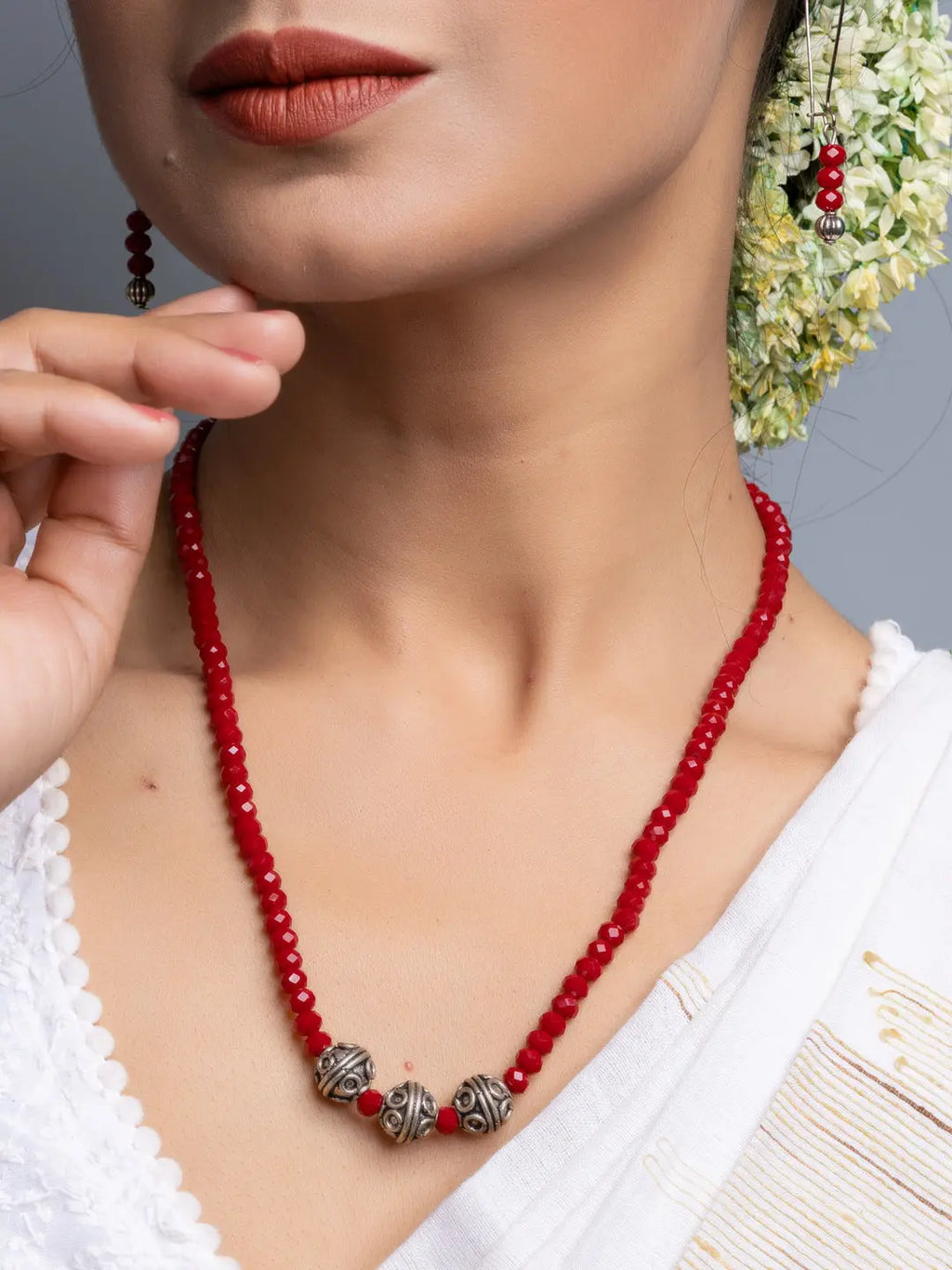 Handmade Red Crystal Necklace Set with silver bead accents worn by woman in white outfit